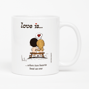 Front view: Love is... when two hearts beat as one personalized ceramic mug by Kim Casali.